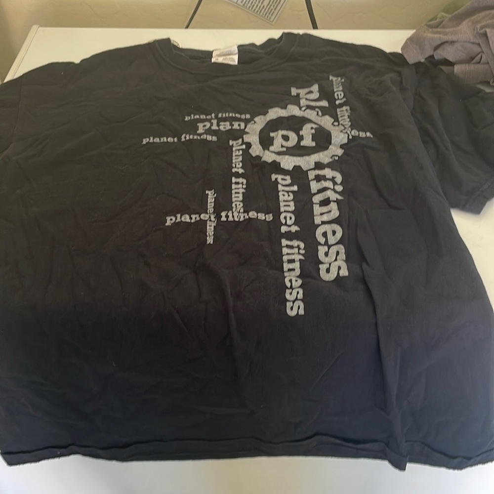 Black shirt planet fitness text